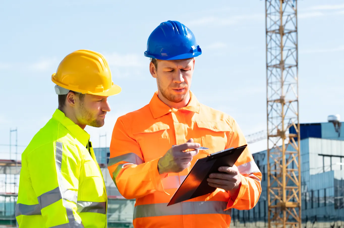 Construction workers discussing plans on-site.
