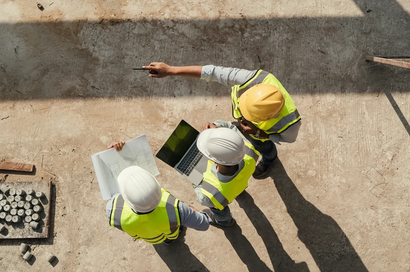 Construction workers reviewing plans on site.
